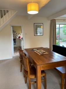 a dining room with a wooden table and chairs at Bluebell Cottage in the Yorkshire Dales in Stainforth