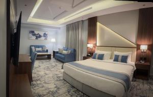 a hotel room with a large bed and a couch at Level Nine Hotel in Jeddah