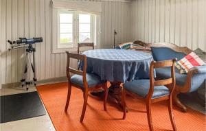 a table and chairs in a room with a camera at Lovely Home In yer With House A Mountain View in Øyer