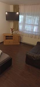a bedroom with two beds and a table and windows at Apartament Slanic Moldova in Slănic-Moldova