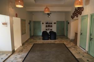 a hallway with two suitcases sitting in the middle of a room at The Brahma Space in Pushkar