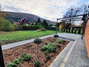 a garden with some plants in a yard at Domek na Polanie in Ustroń