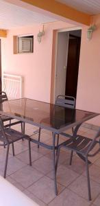 a glass table and two chairs on a patio at Appartement d'une chambre avec terrasse amenagee et wifi a Le Robert in Le Robert