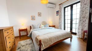 a bedroom with a bed and a large window at Albufeira Calipto by Sunny Deluxe in Albufeira +55 photos