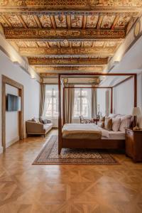 a bedroom with a bed with a wooden ceiling at Hotel Nerudova 211 in Prague