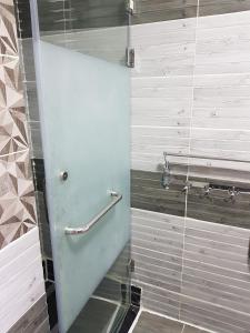 a shower with a glass door in a bathroom at Two Bedroom at Sunny Lakes Resort in Sharm El Sheikh
