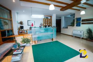 a large living room with a large green rug at Hotel Bermon in Tirana