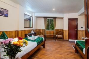 a bedroom with a bed with flowers on it at Muscatel Roma - 400 Mts from Mall Road in Darjeeling