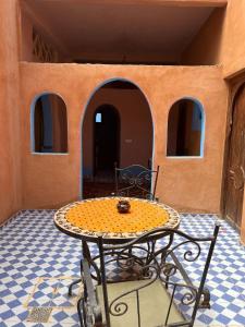 a table in the middle of a room with a table at Riad Aicha & Camel Trekking in Merzouga +83 photos
