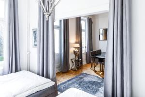 a bedroom with a bed and a desk in a room at Sleephotels Alsterroom in Hamburg