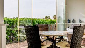 a dining room with a table and chairs and a balcony at Modern Stunning Townhouse 3 bed 2 bath on La Torre CE51LT in Torre-Pacheco