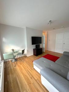 Dormitorio con cama, escritorio y TV en 303 Alexandra Avenue HA2 9DX en Pinner