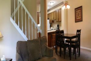 a living room and kitchen with a couch and a table at Lakeview Golf Resort Townhouses in Morgantown