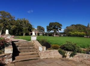a set of stairs leading to a yard with a lawn at Lunan House in Arbroath
