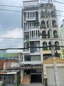 un grand bâtiment blanc avec un hôtel de cuisine dans l'établissement Galaxy Hotel 3, à Hô-Chi-Minh-Ville