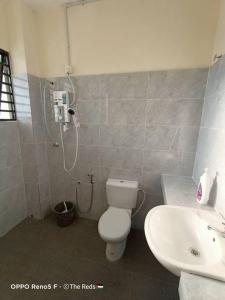 a bathroom with a shower and a toilet and a sink at Homestay Sofiyyah 1 in Temerloh