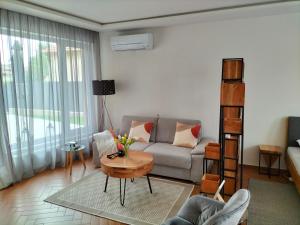 salon z kanapą i stołem w obiekcie Sakura Studio Apartment w mieście Mosonmagyaróvár