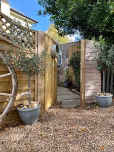 a garden with a wooden fence and a gate at Little Limes an Adorable little Suffolk getaway with outside space near Woodbridge in Eyke