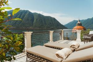 a balcony with a view of the mountains at MUSA Lago di Como in Sala Comacina