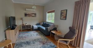 a living room with a couch and a tv at Abbivale Farm Cottage in Harewood