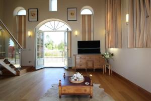 a living room with a tv and a coffee table at The Old Methodist Chapel in Great Massingham