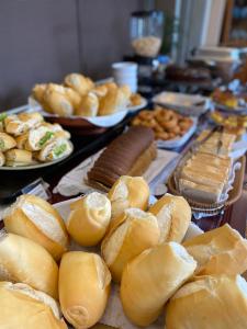 a bunch of breads and other foods on a table at Grande Hotel Minas Gerais in Siqueira Campos