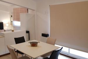 una mesa con sillas y un jarrón encima en Departamento luminoso amplio y silencioso., en Rosario