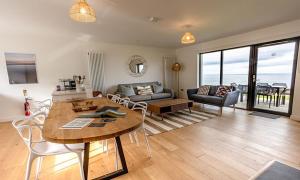 a living room with a table and a couch at 15 - 3 Bedroom Cottage - LP in Nefyn