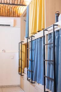 a row of blue curtains in a room at Boutique Hostel Angel in Ljubljana