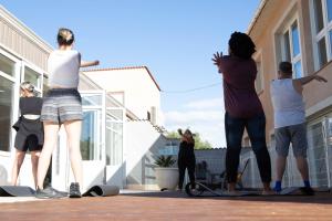 a group of people standing outside of a building at Lodges Méditerranée in Vendres-Plage