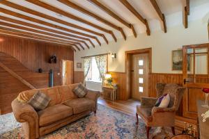 a living room with a couch and two chairs at Chapelton Coachman's Cottage in Kirkcudbright