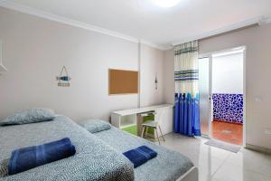 - une chambre avec 2 lits et un bureau dans l'établissement Apartamento Isla Bonita, à Guía de Isora