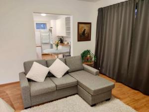 a living room with a couch and a table at Porvoon Kartanonpuisto in Porvoo +15 photos
