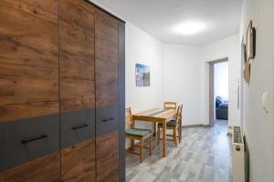 a dining room with a wooden cabinet and a table at Apartament Regina in Szklarska Poręba
