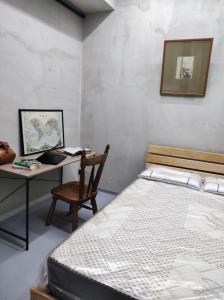 a bedroom with a bed and a desk with a chair at Shared flat in an artists district Pikris Gora in Tbilisi City