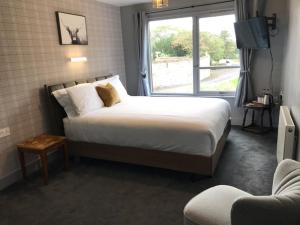 a bedroom with a large bed and a window at Lunan House in Arbroath