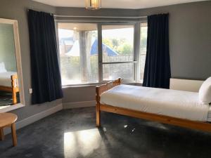 a bedroom with a bed and a large window at Lunan House in Arbroath