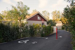 a parking lot in front of a house at Lodges Méditerranée in Vendres-Plage