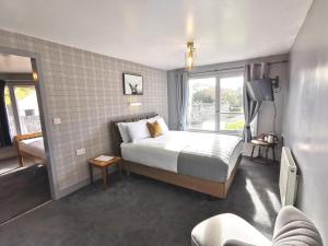 a bedroom with a bed and a large window at Lunan House in Arbroath
