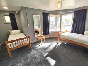 a bedroom with two beds and a window at Lunan House in Arbroath