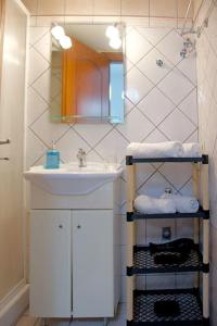 a bathroom with a sink and a mirror at Cozy Apartment In The Heart Of The City in Heraklio Town