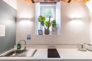 a kitchen counter with a sink and a window at Boutique Hostel Angel in Ljubljana