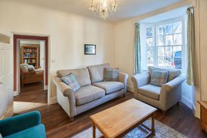 a living room with two chairs and a couch and a table at Host & Stay - Hall Garth in Pickering