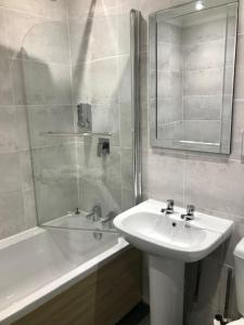 a bathroom with a sink and a shower and a tub at Lunan House in Arbroath