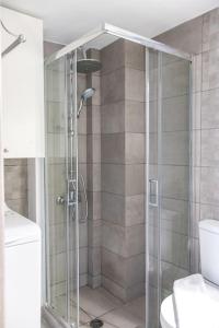 a shower with a glass door in a bathroom at Spacious Flat For Friends & Couples With Balcony in Heraklio