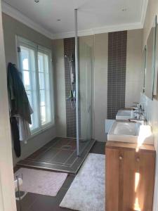 a bathroom with a shower and a sink at Luxury villa with stunning view in Pargas