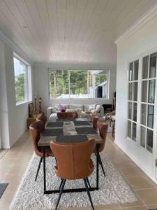 a dining room with a table and chairs in a living room at Luxury villa with stunning view in Pargas