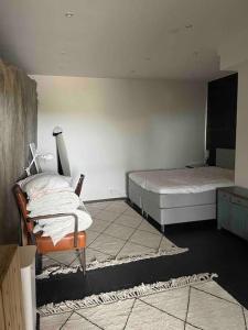 a bedroom with two beds and a chair in it at Luxury villa with stunning view in Pargas