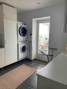 a kitchen with a washing machine in a room at Luxury villa with stunning view in Pargas
