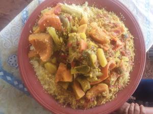 a red plate of food on a table at Khaima in Souk Jemaa des Oulad Abbou